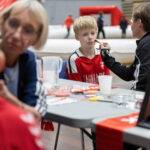 Susanne Cortsen maler ansigter. Fanzone inden Danmark-Finland, U18-landskamp, fodbold Foto: Claus Birch